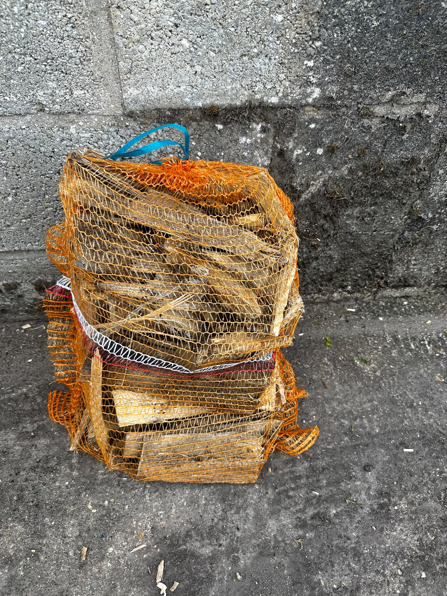 Orange bags of eco kindling made from cleaned log waste