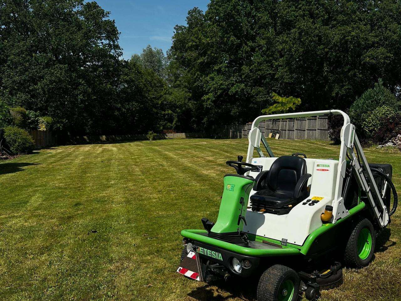 Ride-on mower on maintained grounds